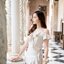 Nella Ruffle Shoulder Dress - สีครีม